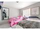 Bedroom featuring two beds, soft natural light, and neutral colored walls at 3145 Tarpon Dr, Las Vegas, NV 89120