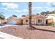 Charming single-story home featuring a desert landscape, tile roof, and inviting arched entryway at 3145 Tarpon Dr, Las Vegas, NV 89120