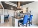 Modern kitchen boasts stainless steel appliances, sleek countertops, and stylish breakfast bar seating at 3145 Tarpon Dr, Las Vegas, NV 89120