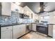 Contemporary kitchen with stainless steel appliances, modern cabinetry, and black countertop at 3145 Tarpon Dr, Las Vegas, NV 89120