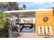 Inviting covered patio with comfortable seating, games, and stylish decor for outdoor enjoyment at 3145 Tarpon Dr, Las Vegas, NV 89120