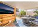 Relaxing covered patio featuring comfortable seating, TV, and a stylish rug for outdoor living at 3145 Tarpon Dr, Las Vegas, NV 89120