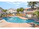 Community pool surrounded by well-maintained landscaping and residential buildings at 3145 Tarpon Dr, Las Vegas, NV 89120