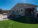 Wide angle photo of a well-maintained backyard with hot tub and outdoor seating at 32 Via Del Fiume, Henderson, NV 89011