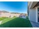 Well-maintained backyard featuring lush artificial grass, a brick patio, hot tub, and outdoor seating at 32 Via Del Fiume, Henderson, NV 89011