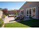 Backyard patio featuring a dining table, spa, and easy access into home at 32 Via Del Fiume, Henderson, NV 89011