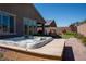 Backyard with patio, lawn, hot tub, lush plants, and privacy wall at 32 Via Del Fiume, Henderson, NV 89011