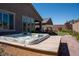 Backyard with hot tub, patio, lawn, landscaping, and privacy wall at 32 Via Del Fiume, Henderson, NV 89011
