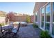 Landscaped backyard features spa, dining set, lush greenery, and privacy at 32 Via Del Fiume, Henderson, NV 89011