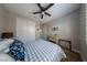 This cozy bedroom features a ceiling fan, closet with white doors, neutral walls, and carpeted floors at 32 Via Del Fiume, Henderson, NV 89011