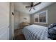 This lovely bedroom has a ceiling fan, closet with white doors, neutral walls, carpeted floors and a window at 32 Via Del Fiume, Henderson, NV 89011