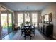 Elegant dining room featuring modern lighting, neutral paint, and easy access to an outdoor seating area at 32 Via Del Fiume, Henderson, NV 89011