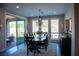 Contemporary dining room featuring a stylish chandelier and access to the outdoor space at 32 Via Del Fiume, Henderson, NV 89011
