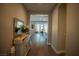 Inviting home entryway featuring wood floors and sightlines into the living and dining spaces at 32 Via Del Fiume, Henderson, NV 89011