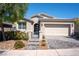 Charming single-story home featuring a two-car garage, desert landscaping, and a welcoming front entrance at 32 Via Del Fiume, Henderson, NV 89011