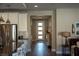Hallway featuring an island with seating, white cabinets, stainless steel appliances, and modern pendant lighting at 32 Via Del Fiume, Henderson, NV 89011