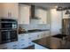 Modern kitchen features stainless steel appliances and dark countertop with white cabinets at 32 Via Del Fiume, Henderson, NV 89011