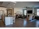 Open-concept living room with a fireplace, seamlessly connects with a modern kitchen at 32 Via Del Fiume, Henderson, NV 89011