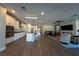 Open concept living space features a sleek kitchen with island and a cozy living room with fireplace at 32 Via Del Fiume, Henderson, NV 89011
