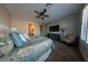 Comfortable main bedroom with ceiling fan, television, side chair, and a beautifully decorated queen sized bed at 32 Via Del Fiume, Henderson, NV 89011