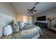 Comfortable carpeted main bedroom with ceiling fan, dresser, television, and a beautifully decorated queen sized bed at 32 Via Del Fiume, Henderson, NV 89011