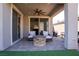 Covered patio featuring a ceiling fan, seating, and an outdoor fire pit at 32 Via Del Fiume, Henderson, NV 89011