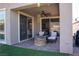 Covered patio featuring a stone fire pit and comfortable seating, perfect for outdoor enjoyment at 32 Via Del Fiume, Henderson, NV 89011