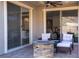 Relaxing patio with fire pit, seating, and sliding glass doors leading indoors at 32 Via Del Fiume, Henderson, NV 89011