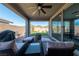 Outdoor patio area featuring comfortable seating, a built-in fire pit, and views of the surrounding landscape and blue sky at 32 Via Del Fiume, Henderson, NV 89011