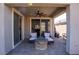 Covered patio featuring a ceiling fan, seating, and an outdoor fire pit at 32 Via Del Fiume, Henderson, NV 89011