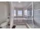 Bathroom featuring a soaking tub, walk-in shower with glass doors, and tile flooring at 3581 Margarita Ave, Pahrump, NV 89048