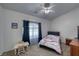 Bright bedroom with a ceiling fan, carpet flooring, and a cozy seating area with a window at 3581 Margarita Ave, Pahrump, NV 89048