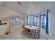 Elegant dining room with a table, chairs, hutch and a large window with sheer blue curtains at 3581 Margarita Ave, Pahrump, NV 89048