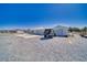 Exterior view features a house with an attached garage and additional separate garage with a desert landscape at 3581 Margarita Ave, Pahrump, NV 89048