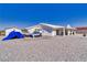 The rear exterior of the property is enhanced with a covered patio and desert landscaping at 3581 Margarita Ave, Pahrump, NV 89048
