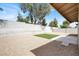 Low maintenance backyard featuring gravel, a concrete patio, and a patch of artificial turf at 4270 Wendy Ln, Las Vegas, NV 89115