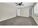 Spacious bedroom featuring neutral paint, a ceiling fan, and plush gray carpeting at 4270 Wendy Ln, Las Vegas, NV 89115