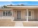 Inviting entryway with covered porch, neutral color scheme, and well-manicured landscaping at 4270 Wendy Ln, Las Vegas, NV 89115