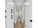 Hallway with wood-style flooring, white cabinets, and doors at 4270 Wendy Ln, Las Vegas, NV 89115