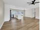 Open-concept living area featuring wood floors and an adjacent updated kitchen with modern appliances at 4270 Wendy Ln, Las Vegas, NV 89115