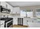 Updated kitchen featuring stainless steel appliances, white cabinets, and quartz countertops at 4270 Wendy Ln, Las Vegas, NV 89115