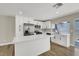 Updated kitchen with white cabinets, stainless steel appliances, an island and access to backyard at 4270 Wendy Ln, Las Vegas, NV 89115