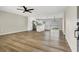 Open-concept living area featuring wood floors and an adjacent updated kitchen with modern appliances at 4270 Wendy Ln, Las Vegas, NV 89115