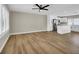 Open-concept living area featuring wood floors and an adjacent updated kitchen with modern appliances at 4270 Wendy Ln, Las Vegas, NV 89115