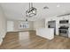 Open-concept living area featuring wood floors and an adjacent updated kitchen with modern appliances at 4270 Wendy Ln, Las Vegas, NV 89115