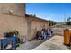 Exterior side yard with potential storage, including gas meters and various tools at 4990 Spring Oak St, Las Vegas, NV 89120