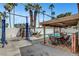 Backyard includes a pool, covered patio with a dining table, and a car lift at 4990 Spring Oak St, Las Vegas, NV 89120