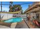 Sparkling swimming pool with diving board, spa, patio furniture, and covered dining area at 4990 Spring Oak St, Las Vegas, NV 89120