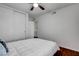 Bedroom with ceiling fan, sliding door closet and a comfortable king-sized bed with white comforter at 4990 Spring Oak St, Las Vegas, NV 89120