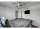 Bedroom with ceiling fan, mounted television, closet and a comfortable queen-sized bed with a grey comforter at 4990 Spring Oak St, Las Vegas, NV 89120